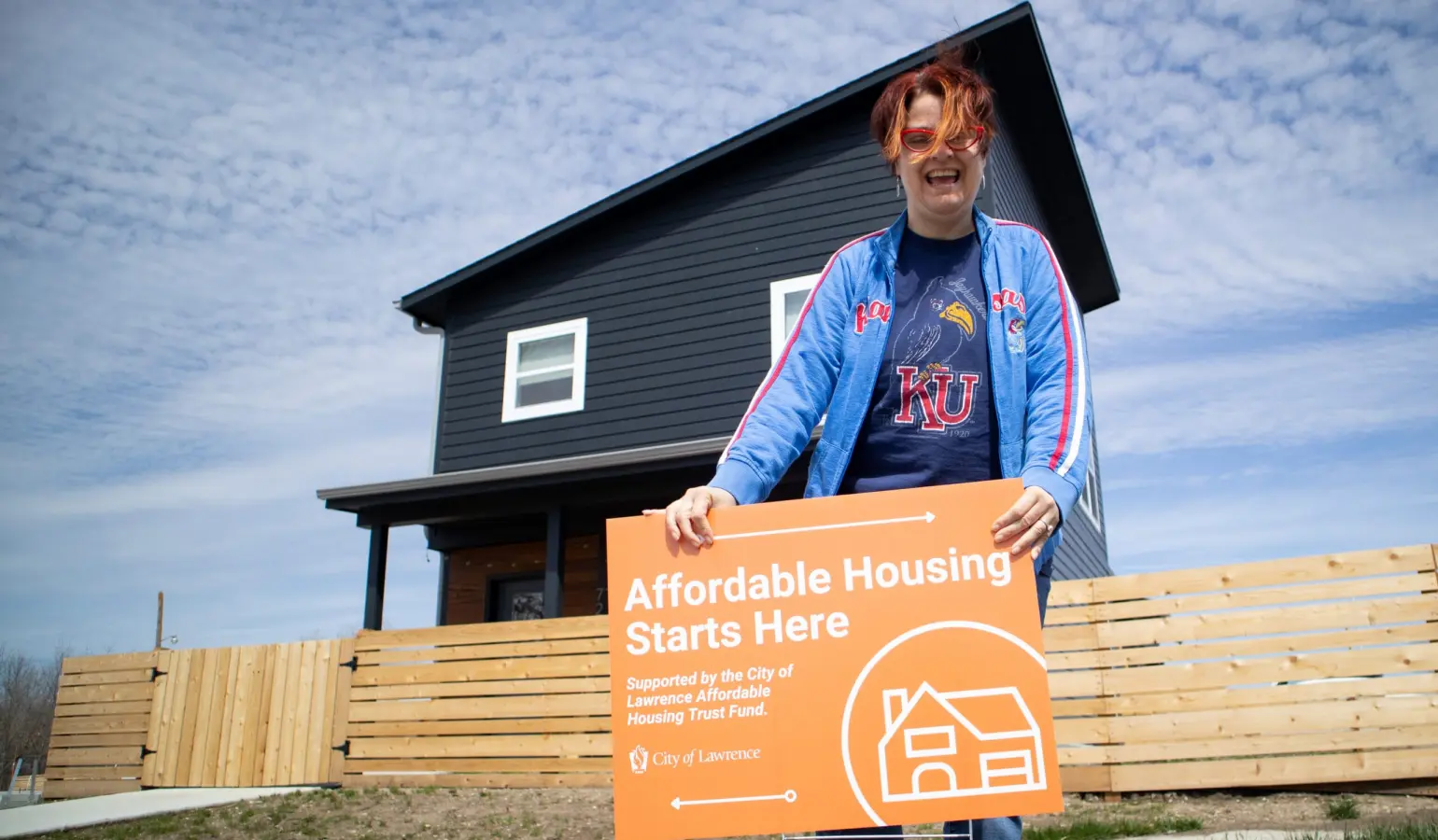 Tenant to Homeowners founder holding sign outside tenant home